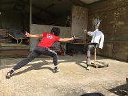 Fencer Wilfred Houston-Brown tries out his moves on a dummy